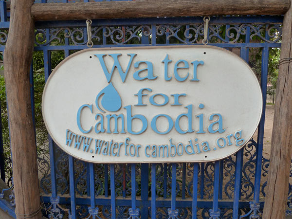 water for cambodia sign on gate of office at lab